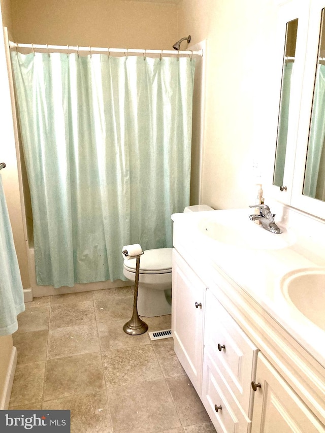 full bathroom featuring toilet, vanity, shower / bathtub combination with curtain, and tile patterned floors