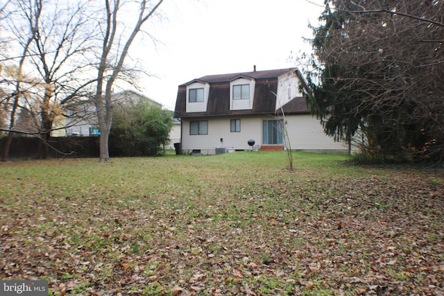 rear view of property featuring a yard