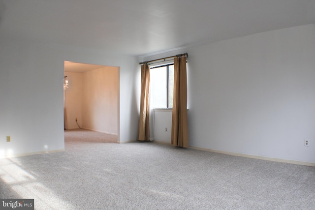 spare room featuring light colored carpet