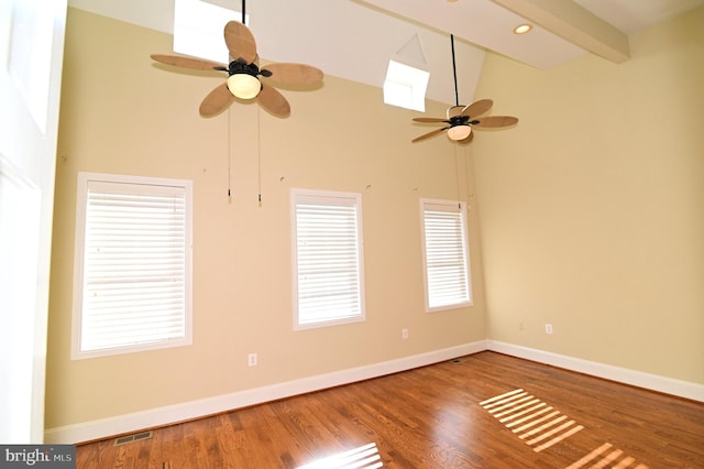 unfurnished room with beamed ceiling, hardwood / wood-style flooring, ceiling fan, and high vaulted ceiling