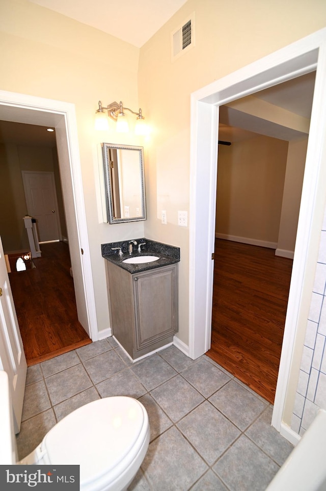 bathroom featuring hardwood / wood-style floors, vanity, and toilet