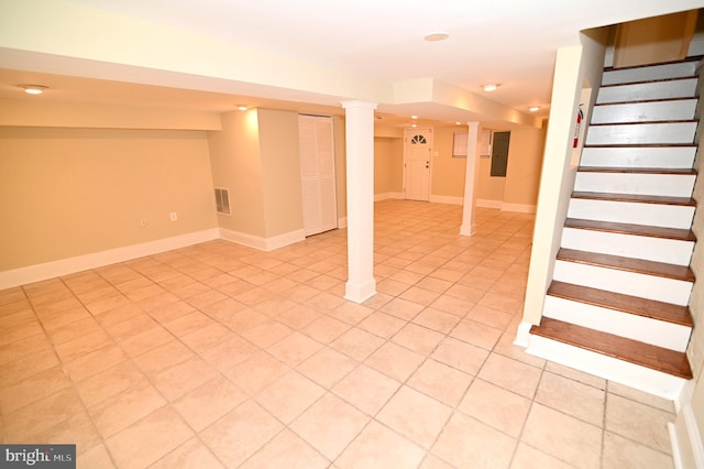 basement featuring electric panel and light tile patterned floors