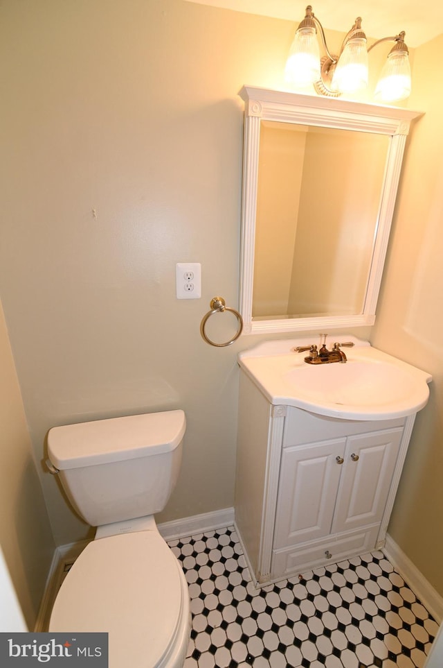 bathroom featuring toilet and vanity