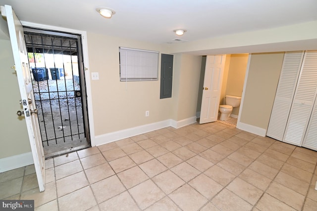 foyer featuring electric panel and light tile patterned floors