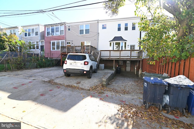 back of house featuring a wooden deck