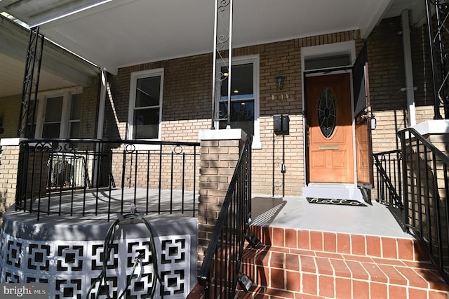 view of exterior entry with a porch