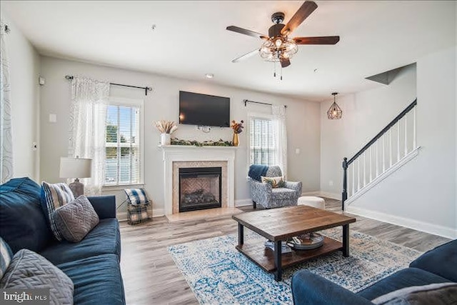 living room featuring ceiling fan and light hardwood / wood-style flooring