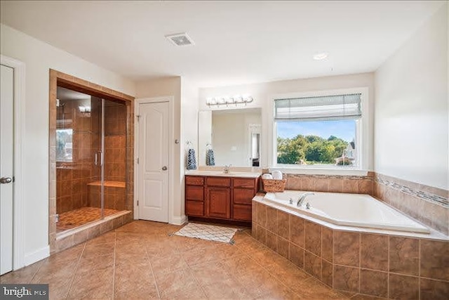 bathroom featuring vanity, independent shower and bath, and tile patterned flooring