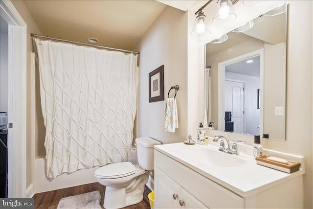 full bathroom with vanity, toilet, wood-type flooring, and shower / bath combo