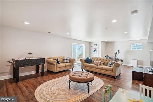 living room featuring a wealth of natural light and dark hardwood / wood-style flooring