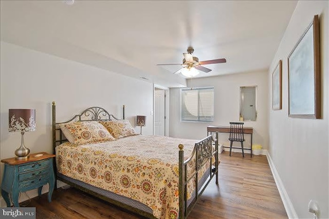 bedroom with dark wood-type flooring, electric panel, and ceiling fan