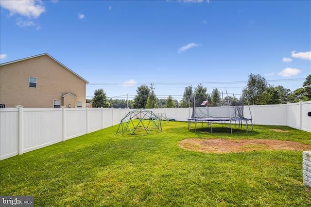 view of yard with a trampoline