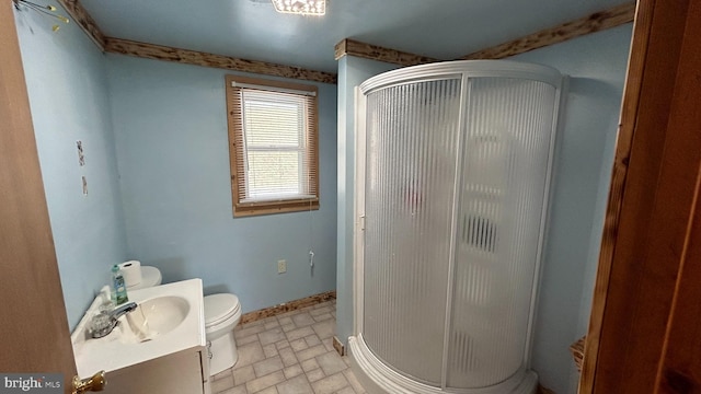 bathroom with toilet, an enclosed shower, and vanity