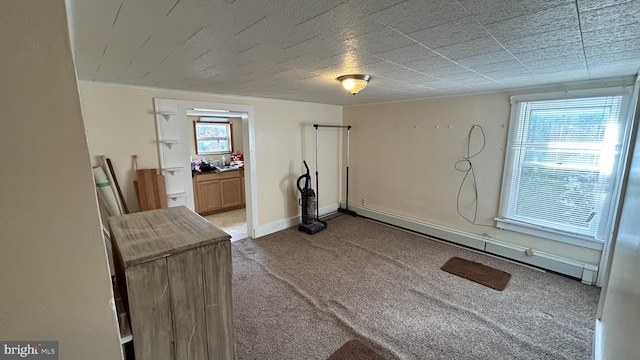 workout room featuring a baseboard radiator and carpet floors