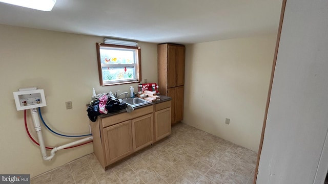 laundry room with cabinets, washer hookup, and sink