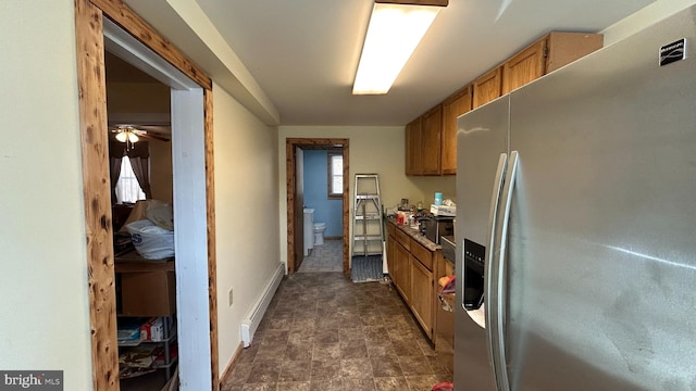 kitchen with ceiling fan, stainless steel fridge with ice dispenser, and a baseboard heating unit