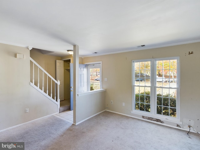 unfurnished room with light colored carpet and crown molding