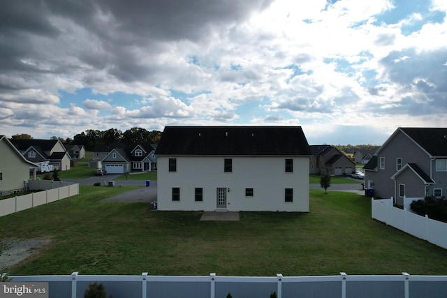 view of home's exterior featuring a lawn and a garage