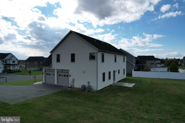 view of side of property featuring a yard and a garage