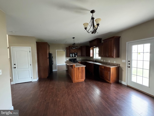 kitchen featuring a kitchen island, dark wood-type flooring, decorative light fixtures, and plenty of natural light