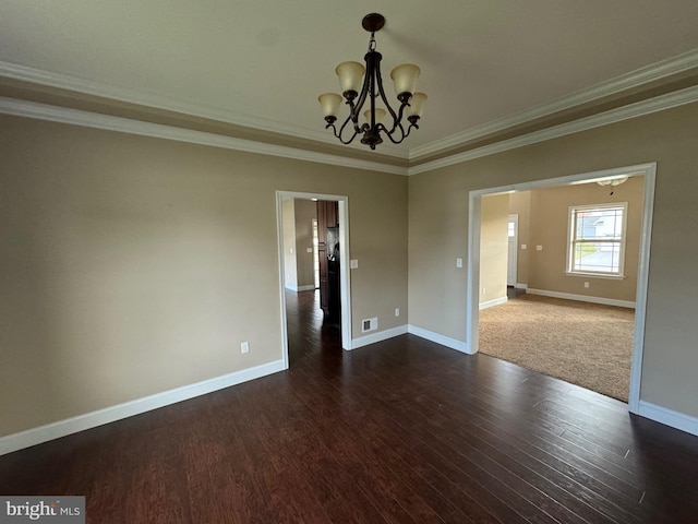 unfurnished room featuring dark wood-type flooring, ornamental molding, and an inviting chandelier