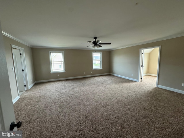 carpeted spare room featuring ceiling fan and ornamental molding