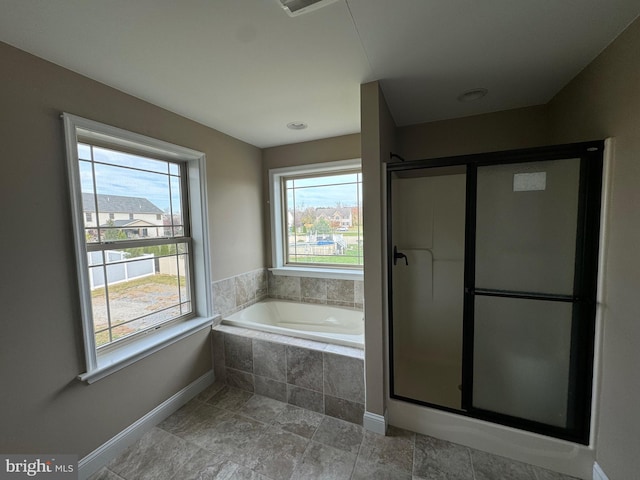 bathroom featuring independent shower and bath