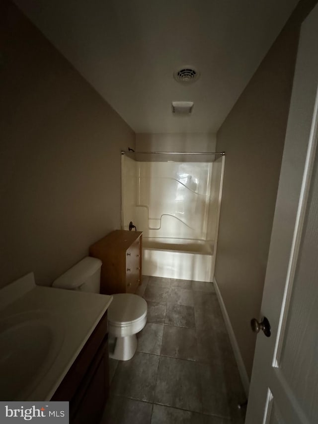 bathroom with toilet, vanity, a shower, and tile patterned floors