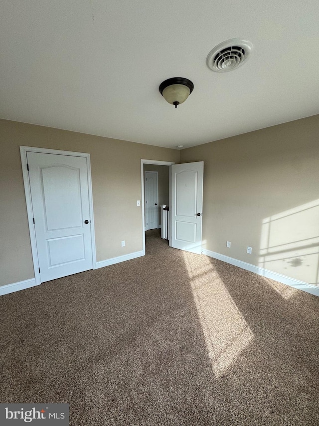 unfurnished bedroom with carpet floors