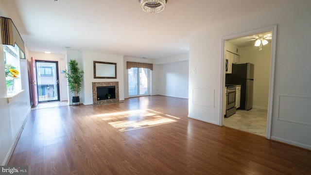 unfurnished living room featuring light hardwood / wood-style flooring and ceiling fan