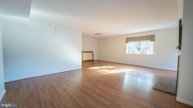 empty room with hardwood / wood-style floors