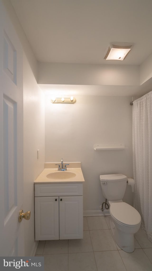 bathroom with vanity, curtained shower, toilet, and tile patterned floors