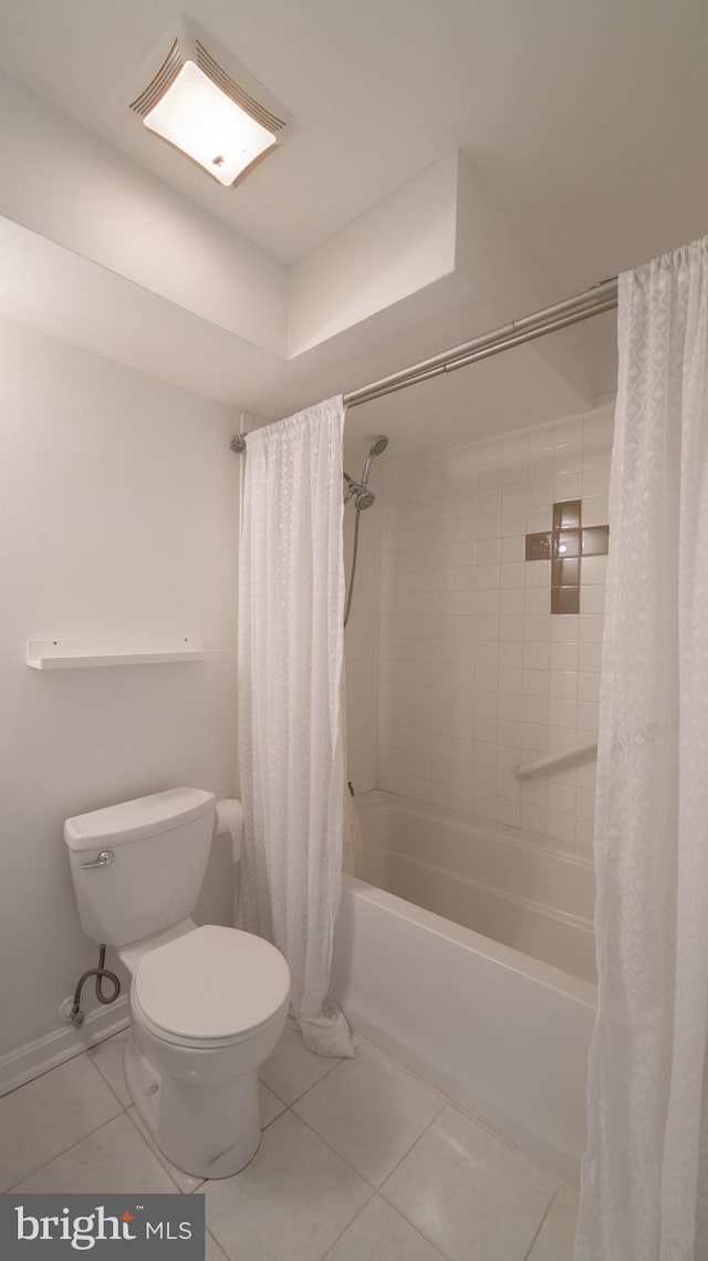 bathroom with toilet, shower / bath combo, and tile patterned flooring