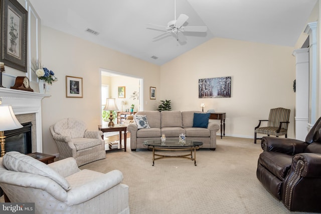 living room featuring light carpet, ceiling fan, and vaulted ceiling