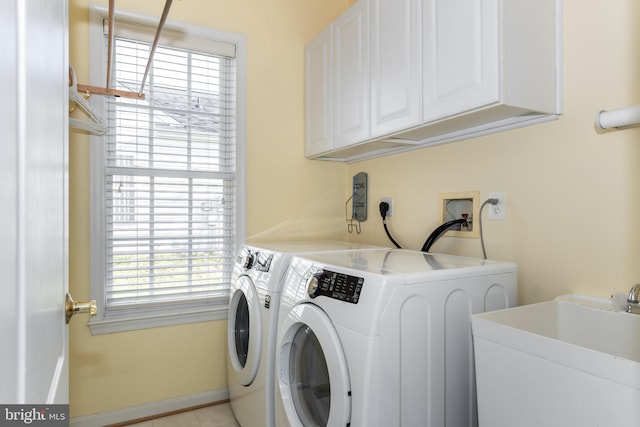 washroom featuring independent washer and dryer, cabinets, sink, and light tile patterned flooring