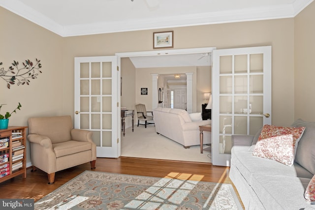 living room with french doors, hardwood / wood-style flooring, and ornamental molding