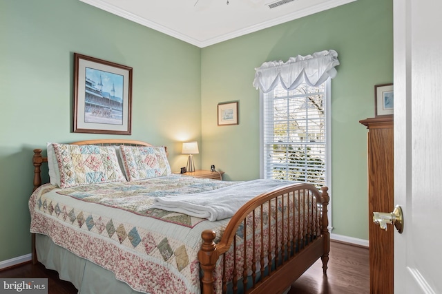 bedroom featuring ornamental molding and dark hardwood / wood-style floors