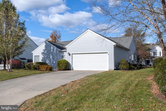 view of side of home featuring a lawn and a garage