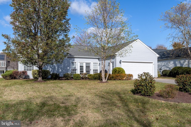 ranch-style house featuring a front lawn and a garage