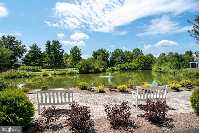 view of community with a water view and a patio area