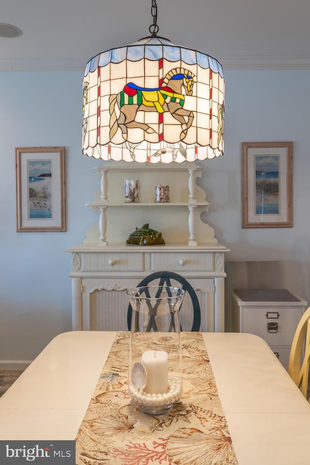 dining space featuring crown molding