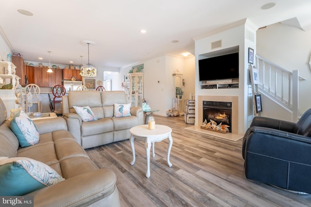 living room featuring ornamental molding and light wood-type flooring