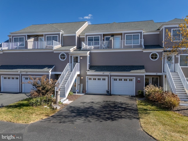 townhome / multi-family property featuring a balcony and a garage