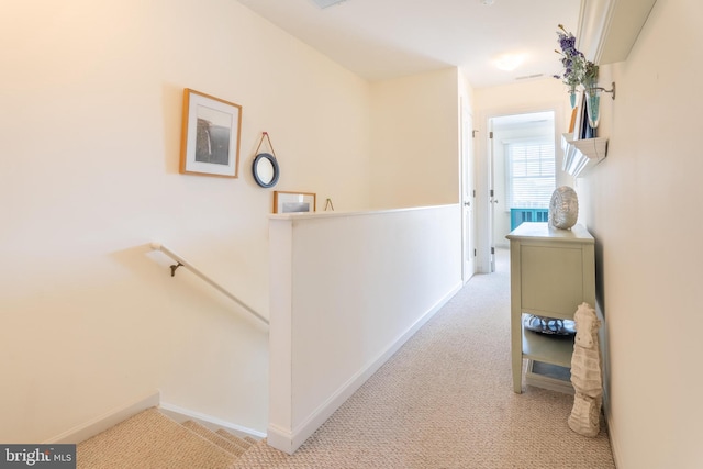 hallway featuring light colored carpet