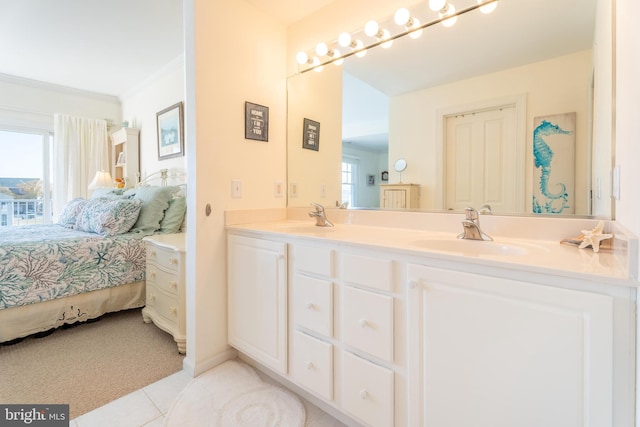 bathroom featuring vanity, crown molding, and tile patterned flooring