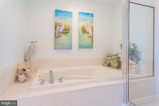 bathroom featuring a relaxing tiled tub