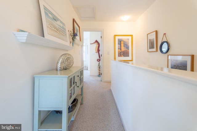 hall featuring light colored carpet