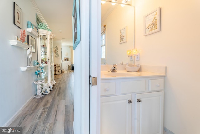 interior space with crown molding, wood-type flooring, and sink