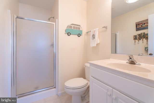 bathroom with vanity, a shower with shower door, toilet, and tile patterned flooring