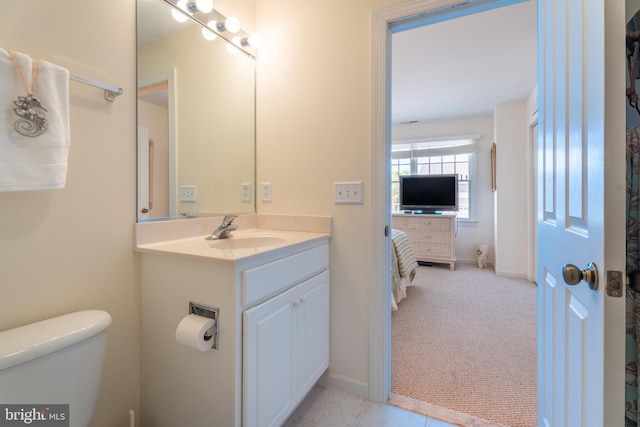 bathroom featuring vanity, toilet, and tile patterned floors